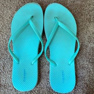 Neon blue flip flops
